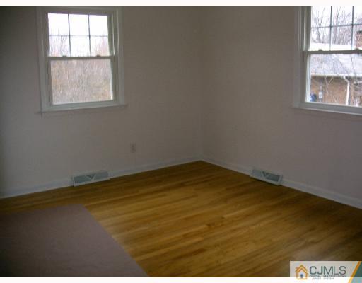 432 Morristown Road Old Bridge, NJ 07747 - Photo 3 of 6 an empty room with a window