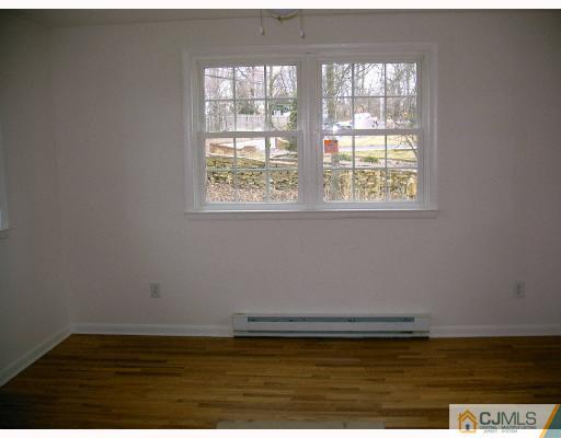 432 Morristown Road Old Bridge, NJ 07747 - Photo 4 of 6 a view of wooden floor and windows in a room