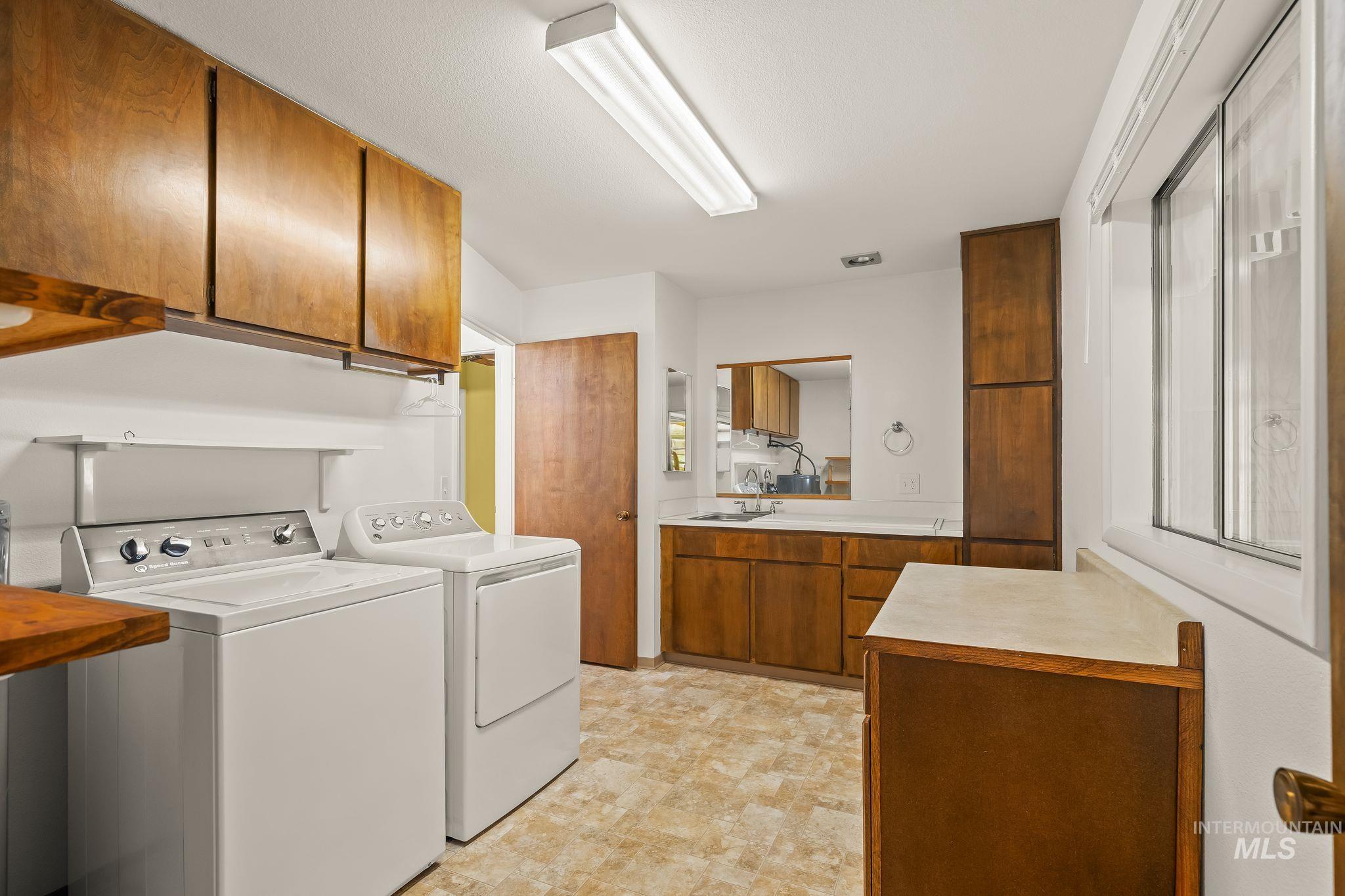 1721 3rd Street Lewiston, ID 83501 - Photo 12 of 45 Kitchen featuring wood cabinetry, a double basin stainless steel sink, white countertops, and white appliances