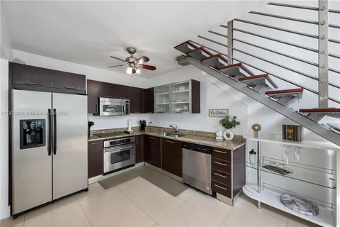 a kitchen with stainless steel appliances granite countertop a stove and a refrigerator