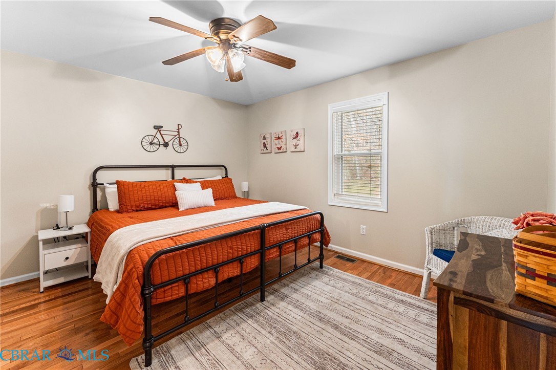 4775 Stormont Road Hartfield, VA 23071 - Photo 35 of 45 Bedroom featuring light wood-style flooring and a ceiling fan