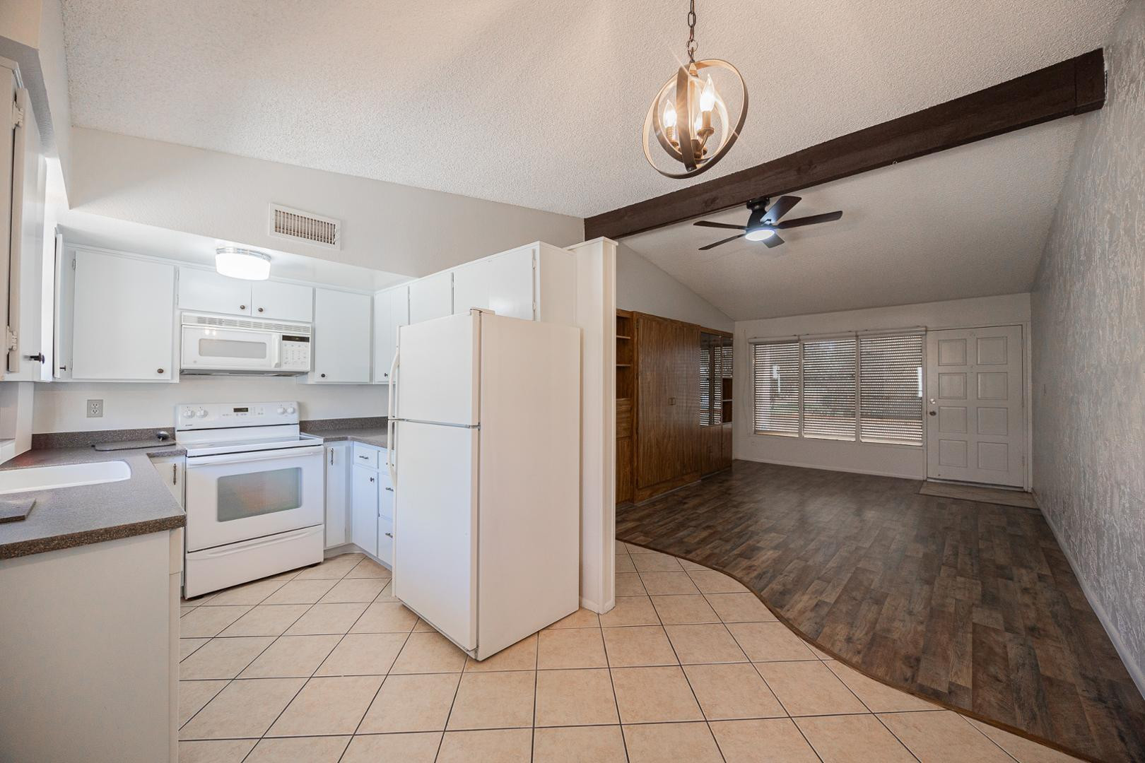 609 South Power Road, Unit 338 Mesa, AZ 85206 - Photo 9 of 24 a kitchen with white cabinets and white appliances
