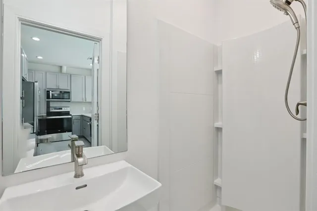 a view of a bathroom with a sink and mirror