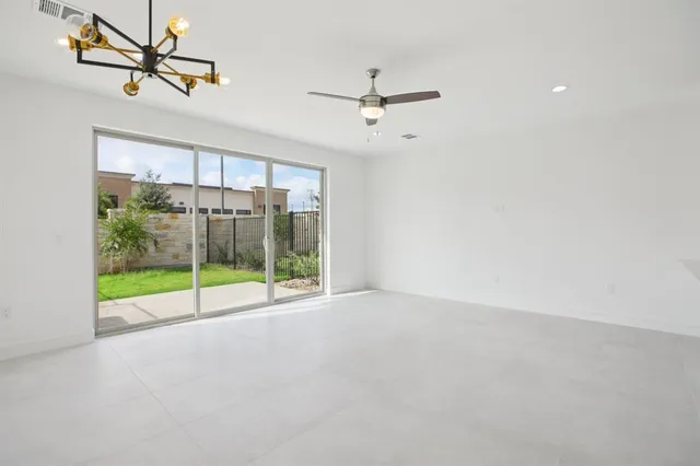 a view of room with window and ceiling fan