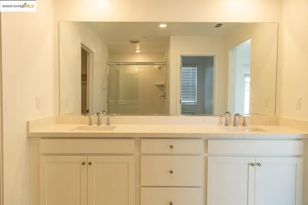 a bathroom with a glass shower door