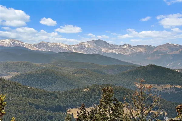 a view of a dry yard with mountains in the background