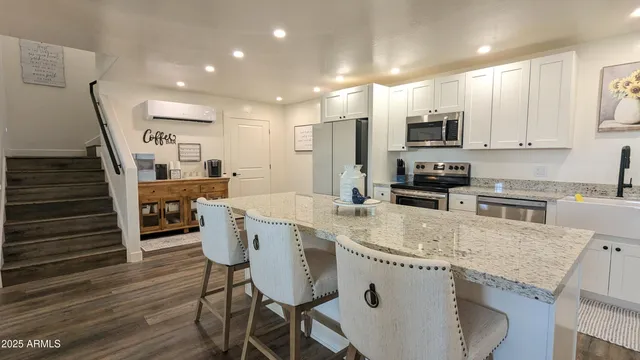 a kitchen with a refrigerator a stove a sink and a microwave