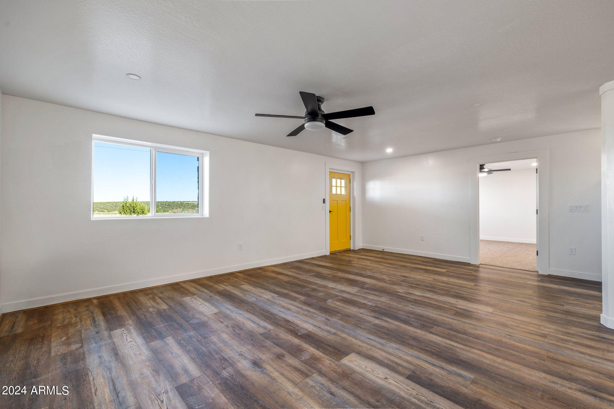157 Frontage Road Concho, AZ 85924 - Photo 31 of 69 a view of an empty room with a window and wooden floor