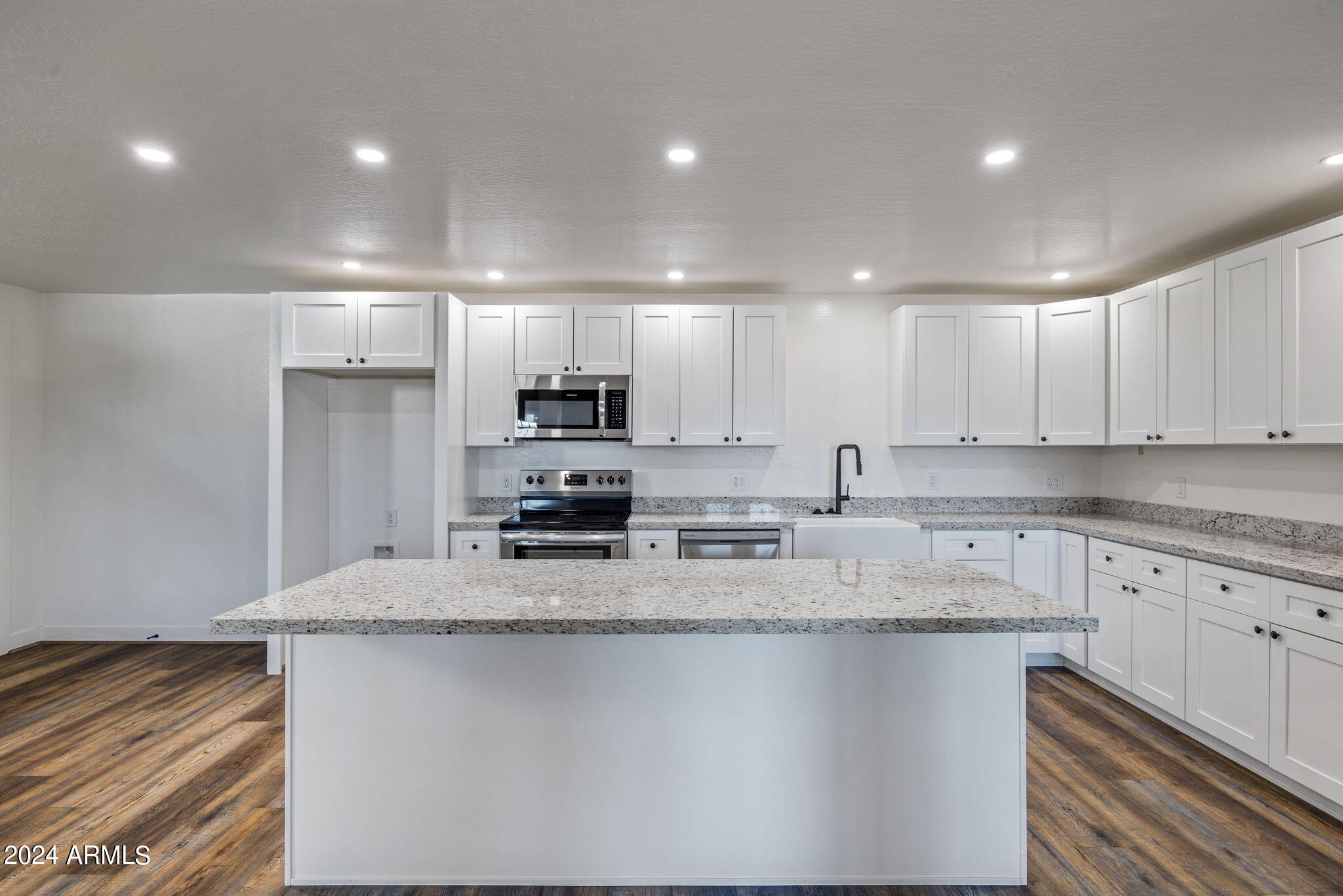 157 Frontage Road Concho, AZ 85924 - Photo 33 of 69 a kitchen with stainless steel appliances granite countertop a sink a stove a refrigerator and white cabinets
