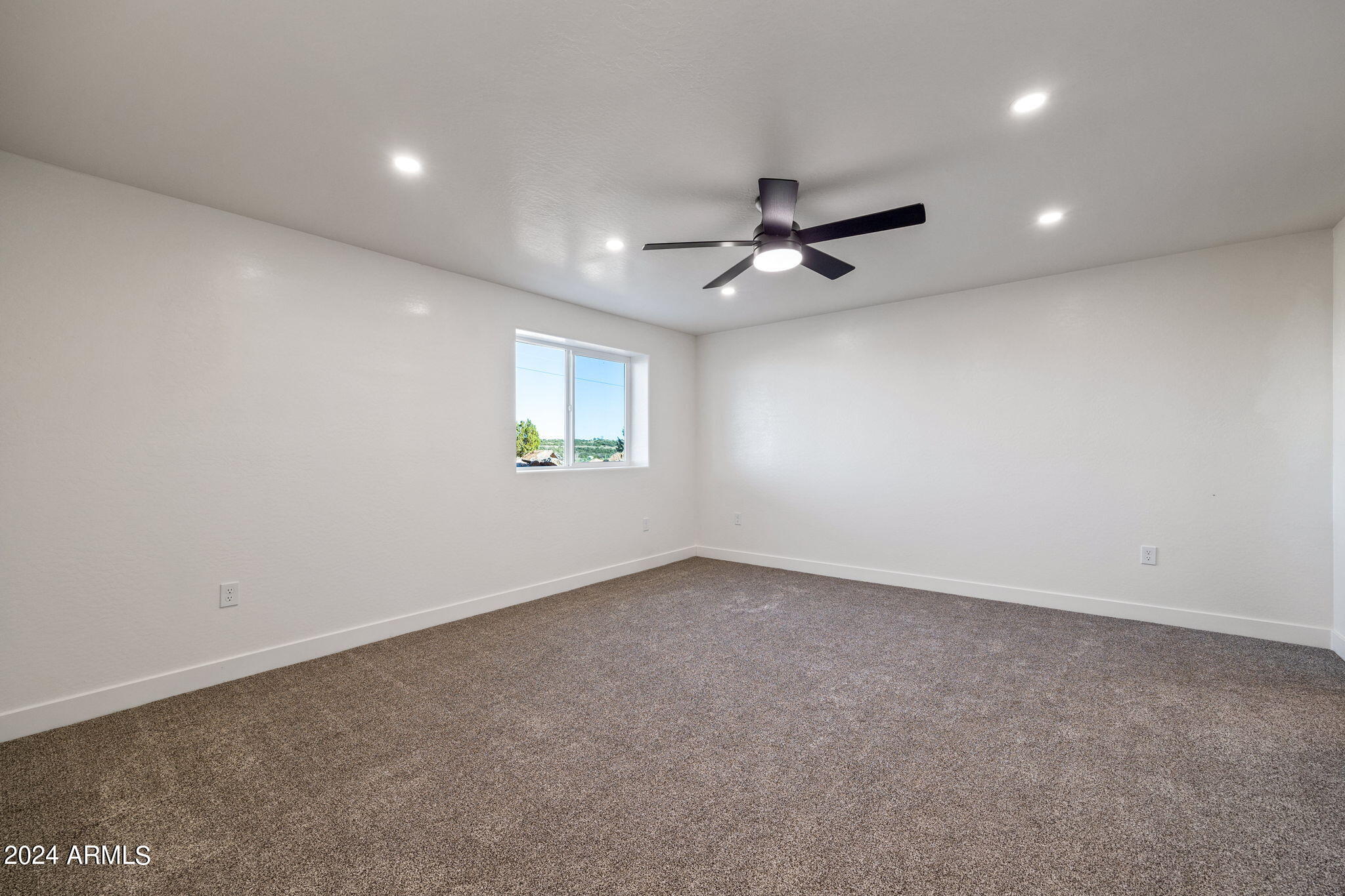 157 Frontage Road Concho, AZ 85924 - Photo 37 of 69 an empty room with a empty space and a ceiling fan