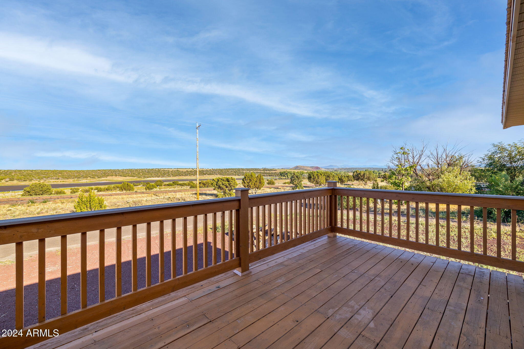 157 Frontage Road Concho, AZ 85924 - Photo 48 of 69 a view of a balcony with wooden floor and fence