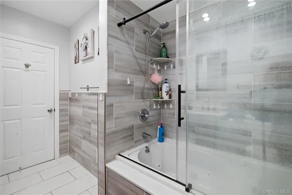 a bathroom with a bathtub and a shower