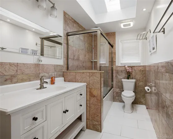 a bathroom with a double vanity sink mirror and toilet