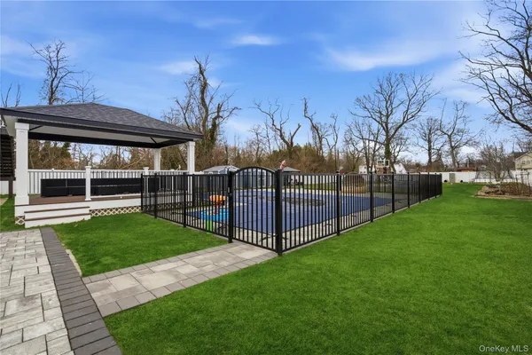 a view of a yard with a large tree