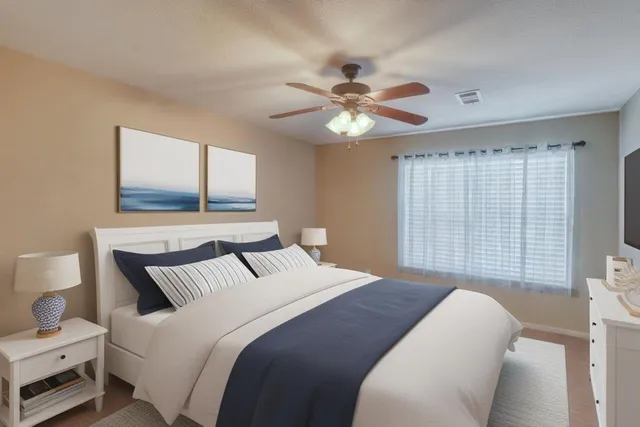 a bedroom with a large bed and a window