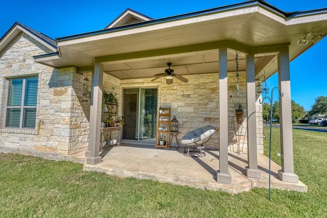 a view of a chair and table in front of house