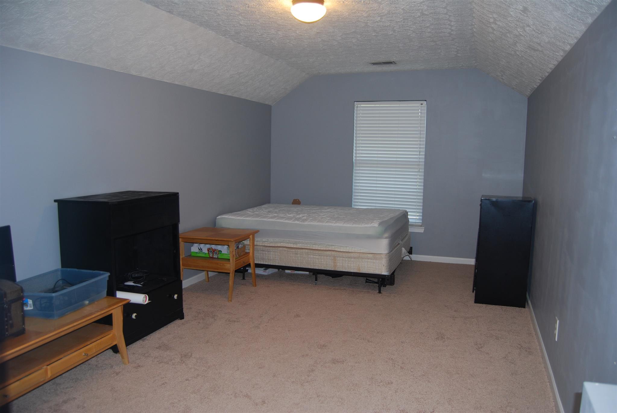 3623 Mahlon Moore Road Spring Hill, TN 37174 - Photo 22 of 29 a bedroom with a bed and a chair