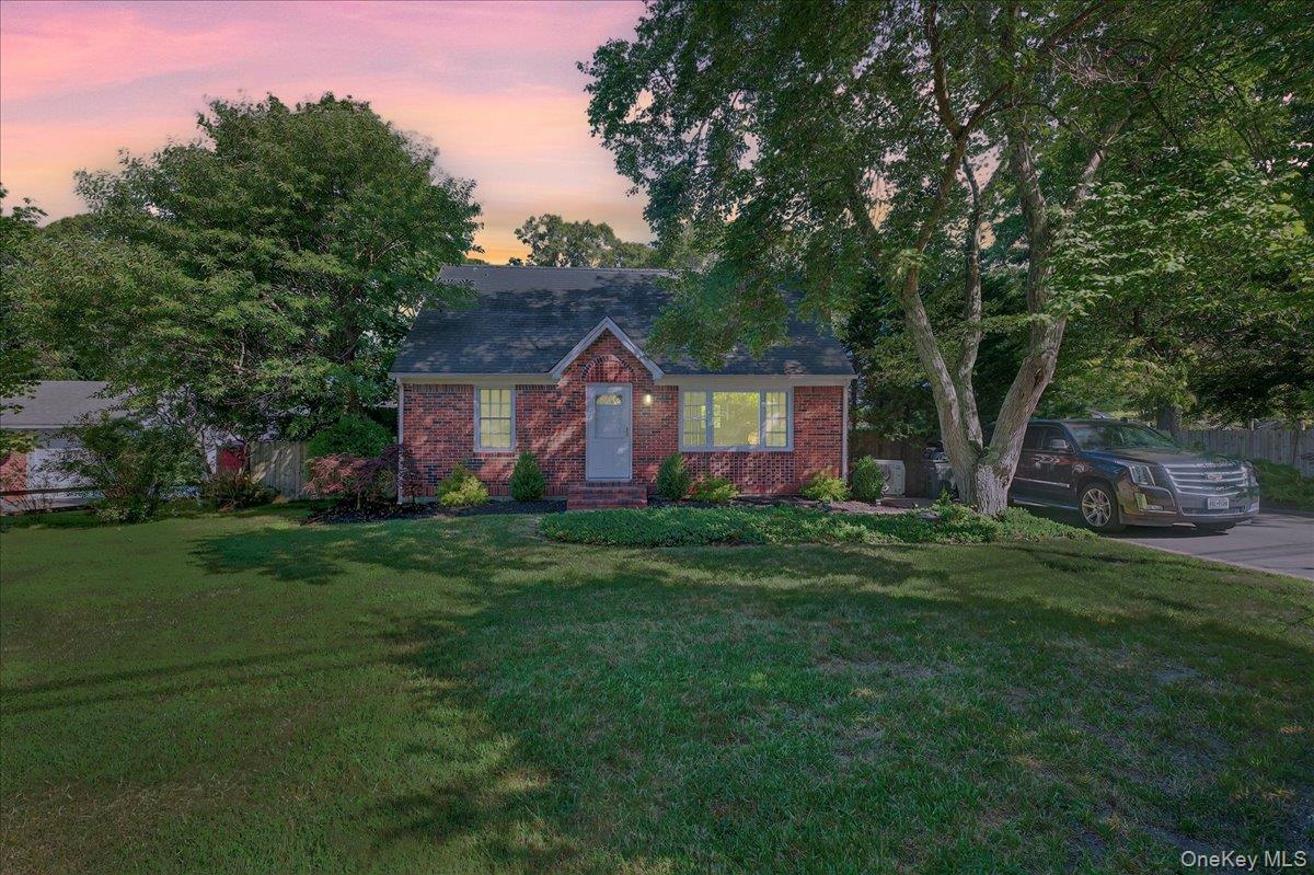 188 Donegan Avenue East Patchogue, NY 11772 - Photo 1 of 25 a front view of a house with a garden