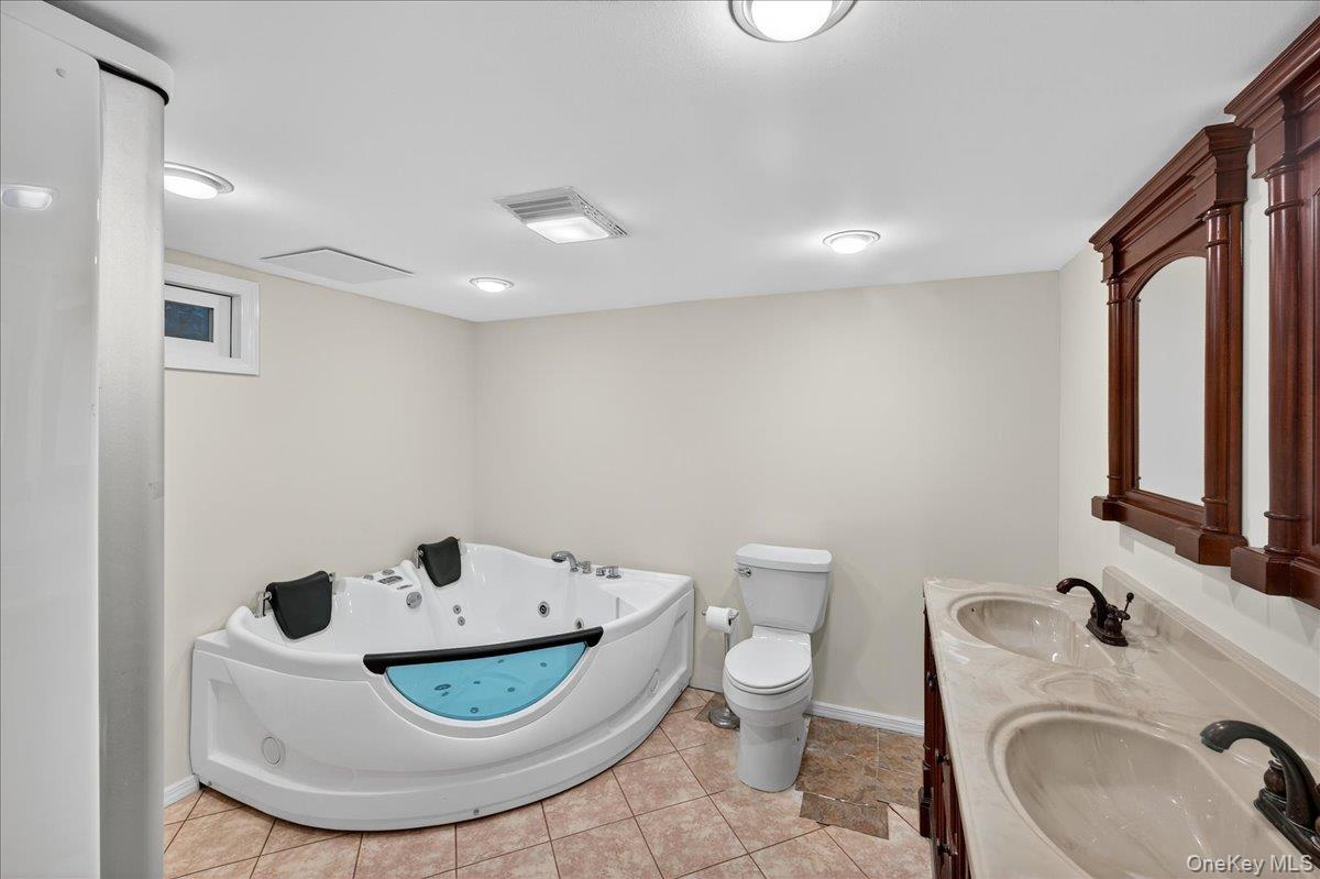 188 Donegan Avenue East Patchogue, NY 11772 - Photo 13 of 25 a bathroom with a toilet sink and mirror