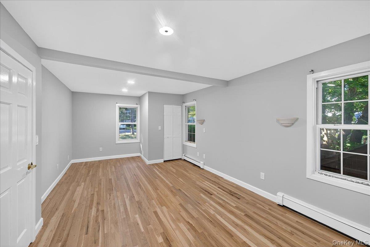 188 Donegan Avenue East Patchogue, NY 11772 - Photo 21 of 25 a view of an empty room with wooden floor and a window