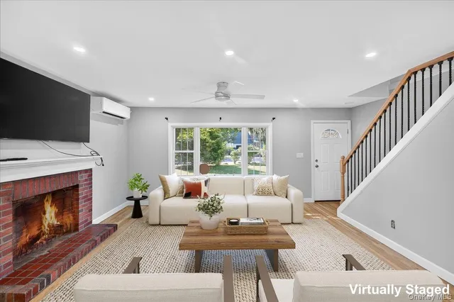 a living room with furniture a fireplace and a flat screen tv