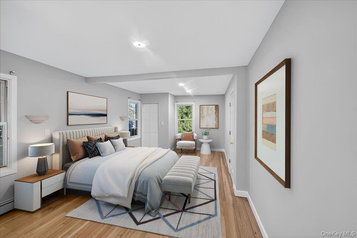 188 Donegan Avenue East Patchogue, NY 11772 - Photo 25 of 25 a bedroom with a bed and wooden floor