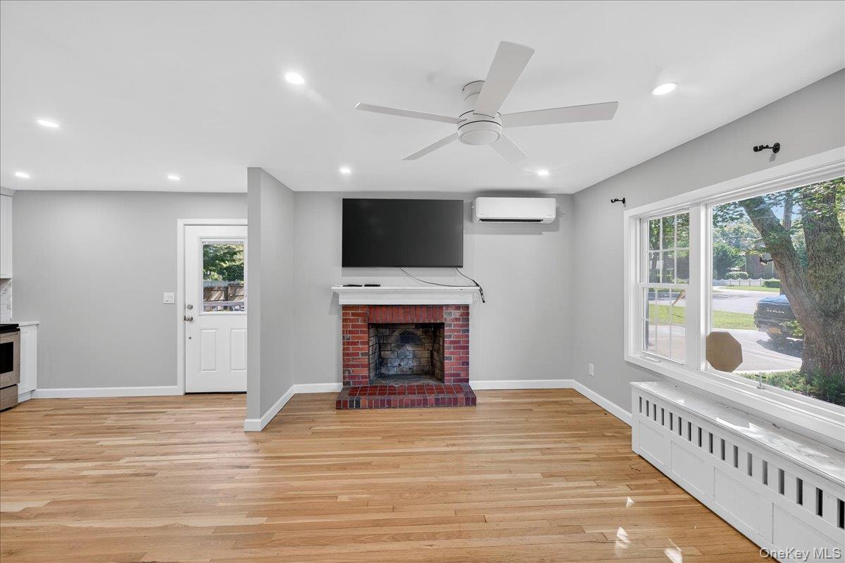 188 Donegan Avenue East Patchogue, NY 11772 - Photo 3 of 25 a view of an empty room with a fireplace and a window