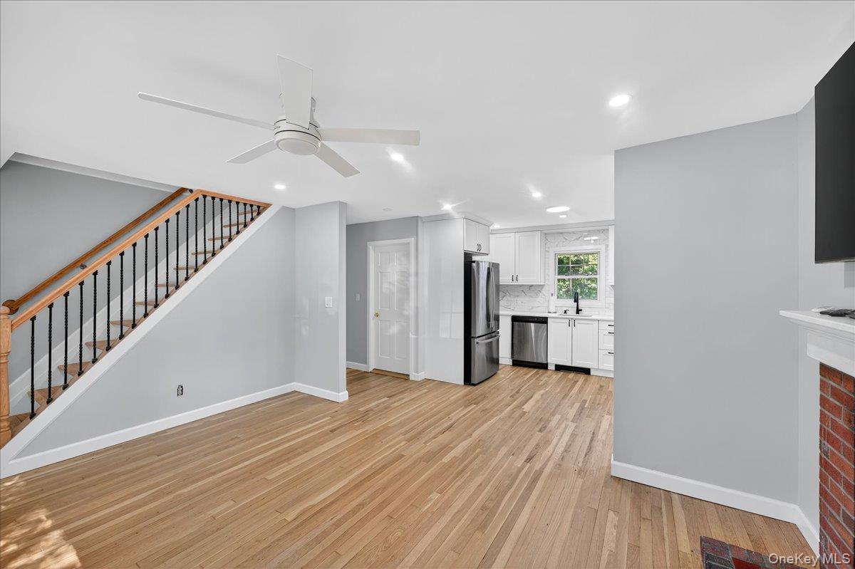 188 Donegan Avenue East Patchogue, NY 11772 - Photo 4 of 25 a view of a hallway with wooden floor and kitchen