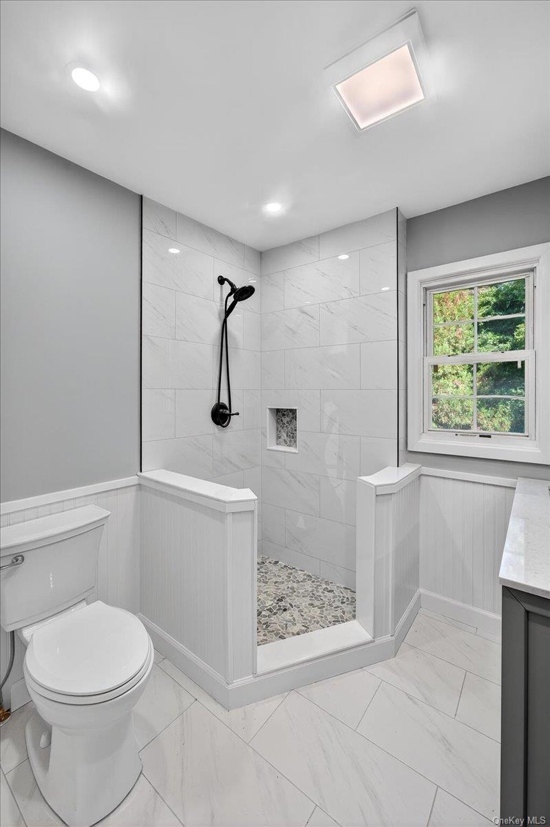 188 Donegan Avenue East Patchogue, NY 11772 - Photo 7 of 25 a bathroom with a sink a toilet and shower