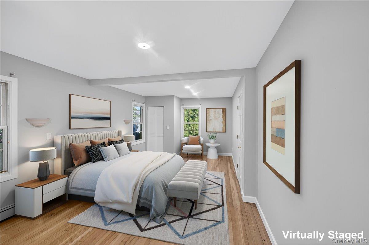 188 Donegan Avenue East Patchogue, NY 11772 - Photo 8 of 25 a bedroom with a bed and wooden floor