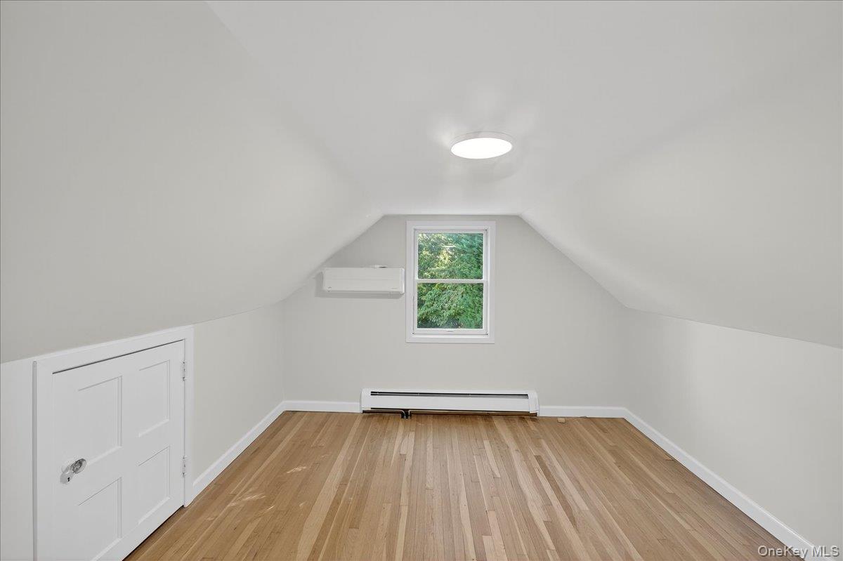 188 Donegan Avenue East Patchogue, NY 11772 - Photo 9 of 25 an empty room with wooden floor and windows