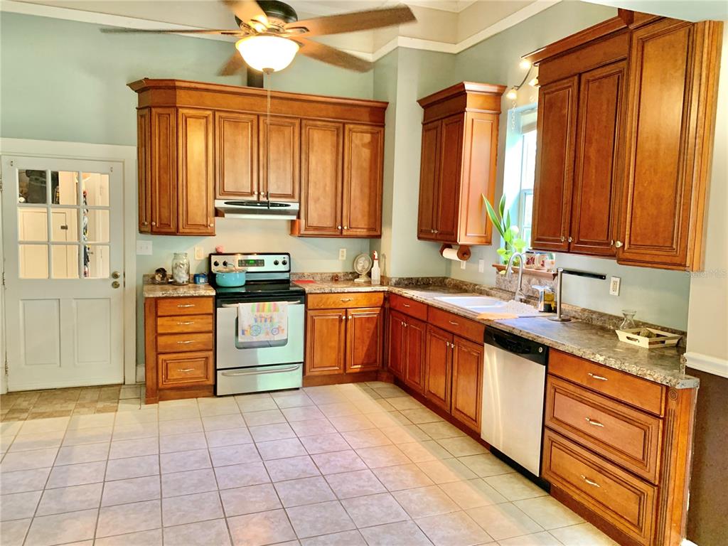 9150 Southwest 151st Lane Archer, FL 32618 - Photo 11 of 81 a kitchen with stainless steel appliances granite countertop a stove a sink and a refrigerator
