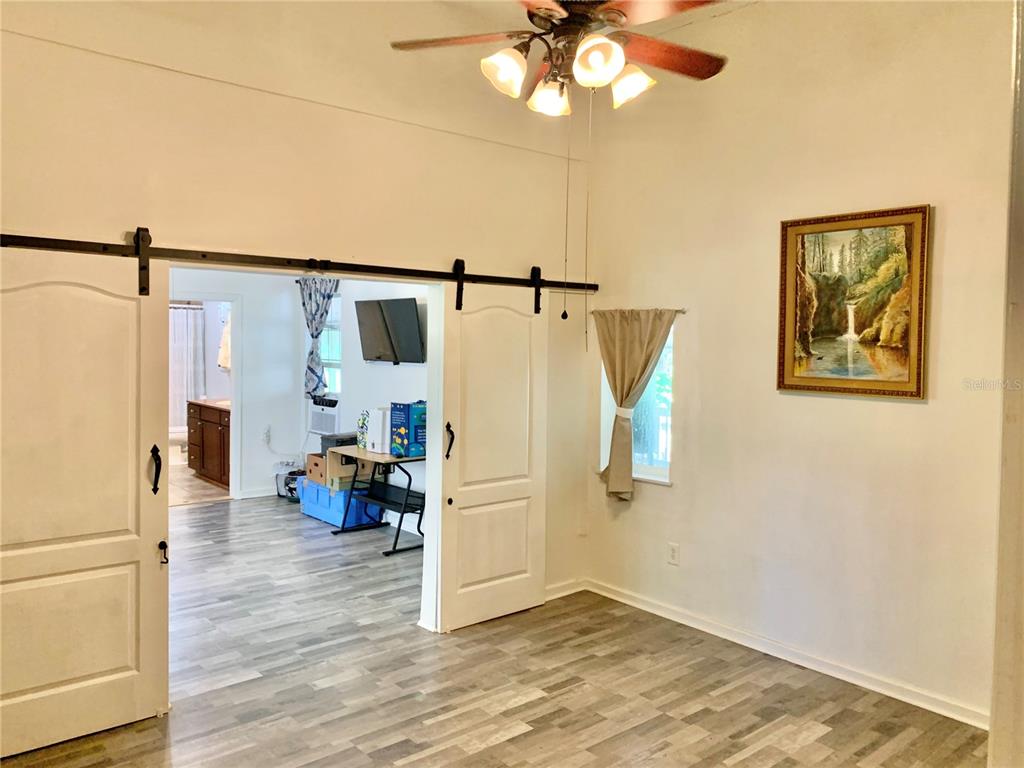 9150 Southwest 151st Lane Archer, FL 32618 - Photo 17 of 81 a view of a storage & utility room with wooden floor