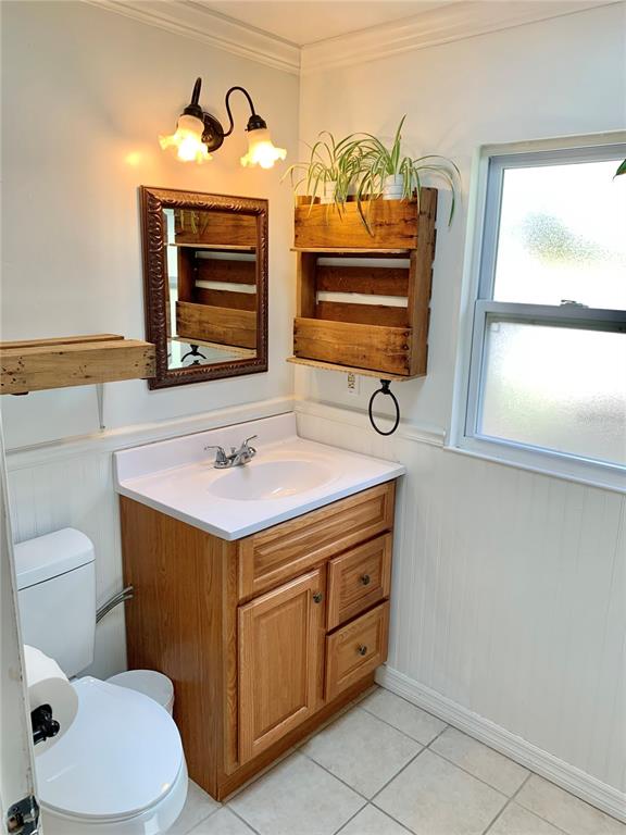 9150 Southwest 151st Lane Archer, FL 32618 - Photo 30 of 81 a bathroom with a toilet a sink and a window
