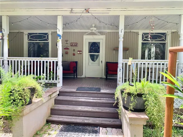 a view of a livingroom with furniture wooden floor and front door