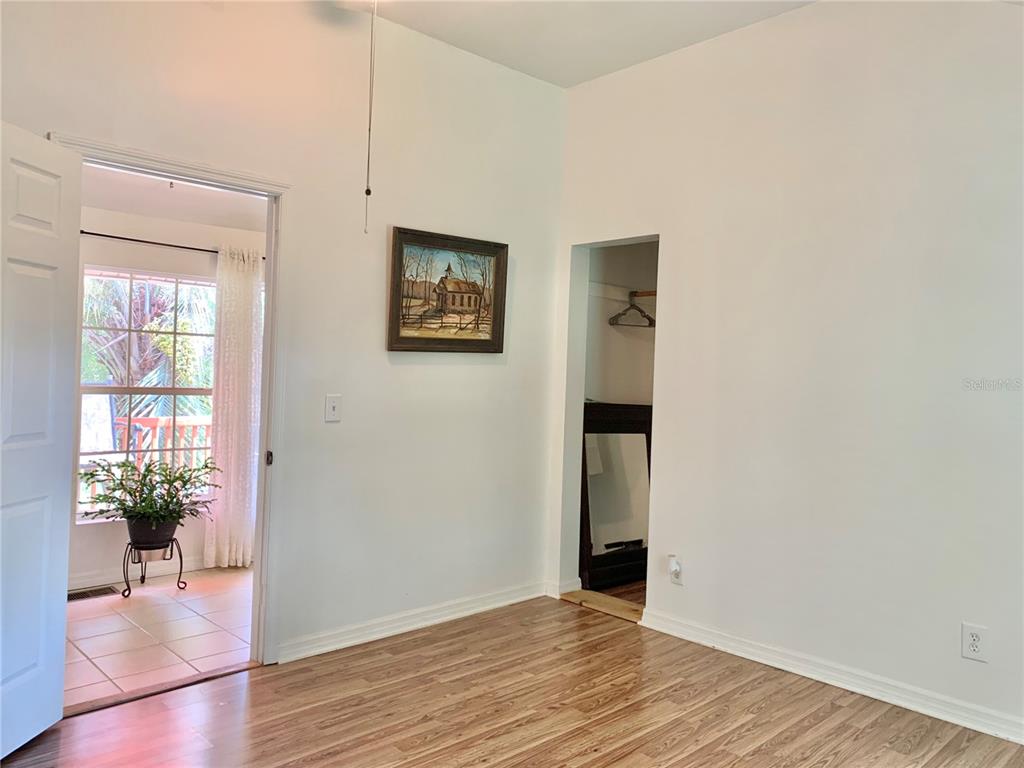 9150 Southwest 151st Lane Archer, FL 32618 - Photo 33 of 81 a view of a hallway with wooden floor and a living room