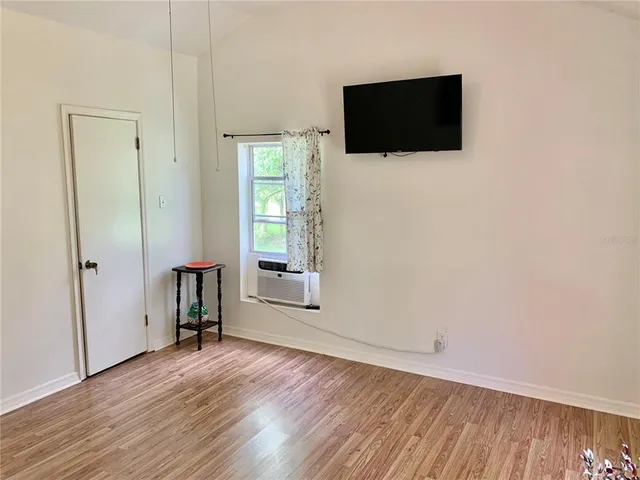 a view of a table and chairs in back yard of a house