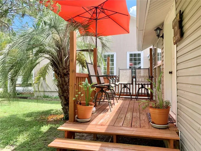 a backyard of a house with a yard and outdoor seating