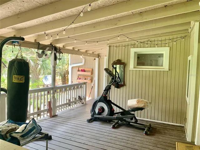 a view of an house with backyard and porch