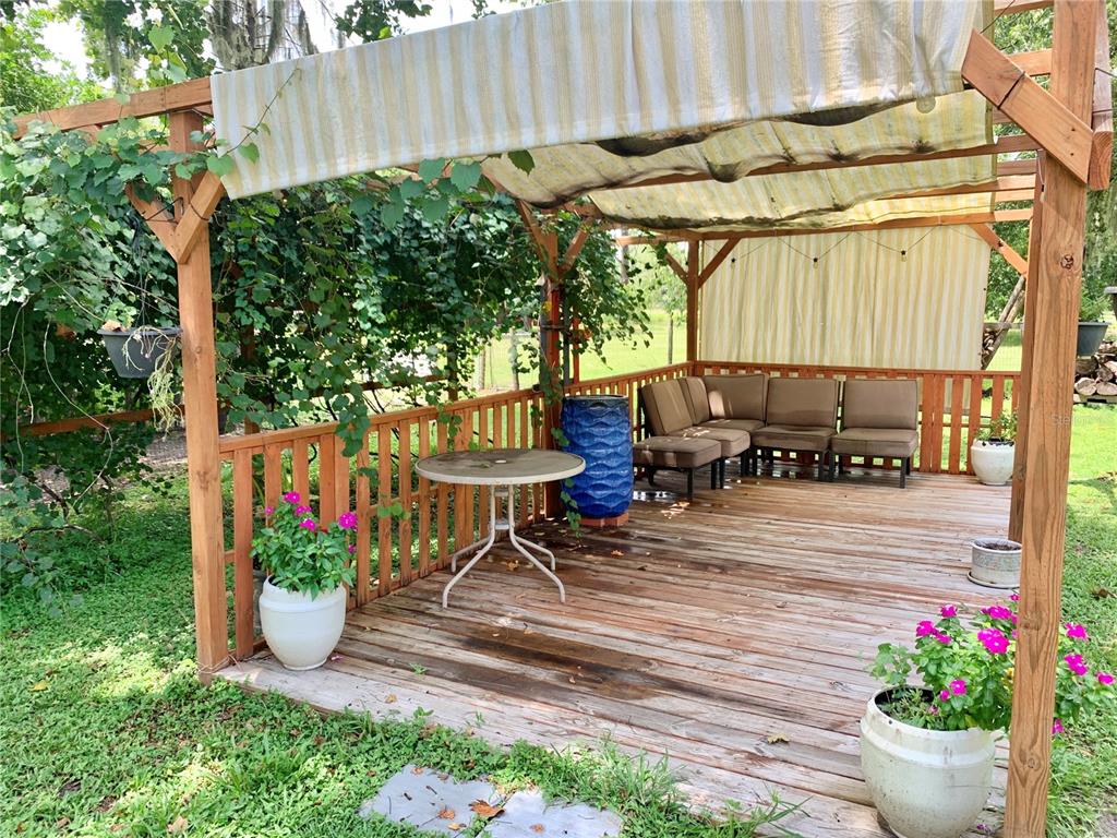 9150 Southwest 151st Lane Archer, FL 32618 - Photo 50 of 81 a view of a table and chairs in back yard of a house