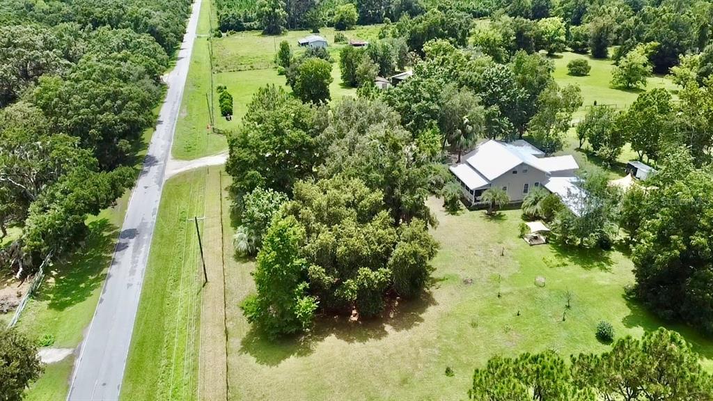 9150 Southwest 151st Lane Archer, FL 32618 - Photo 60 of 81 a backyard of a house with a yard and outdoor seating
