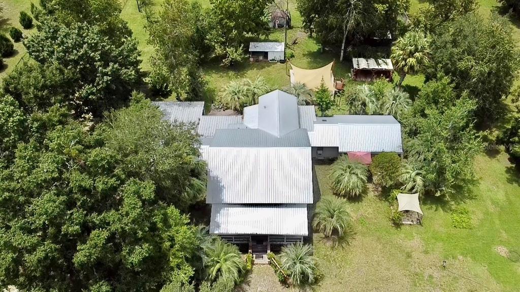 9150 Southwest 151st Lane Archer, FL 32618 - Photo 70 of 81 an aerial view of a house with a yard and trees all around