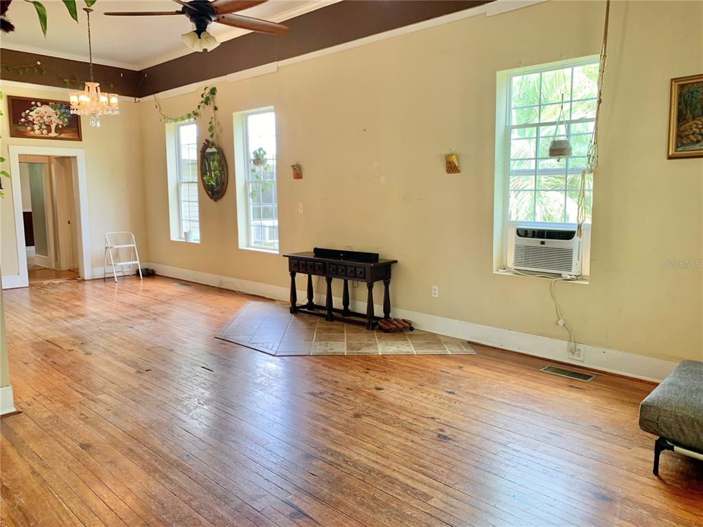 9150 Southwest 151st Lane Archer, FL 32618 - Photo 8 of 81 a view of an empty room with wooden floor and a window