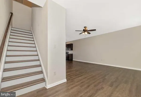 a view of a big room with wooden floor and windows in a room