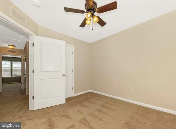 a view of a livingroom with a chandelier fan