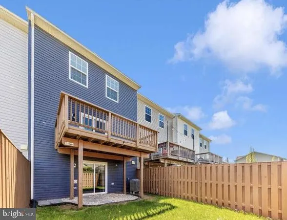 a view of a house with wooden deck