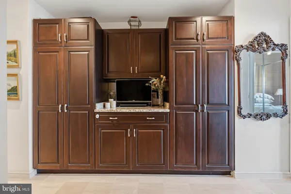 a view of a closet with wooden floor