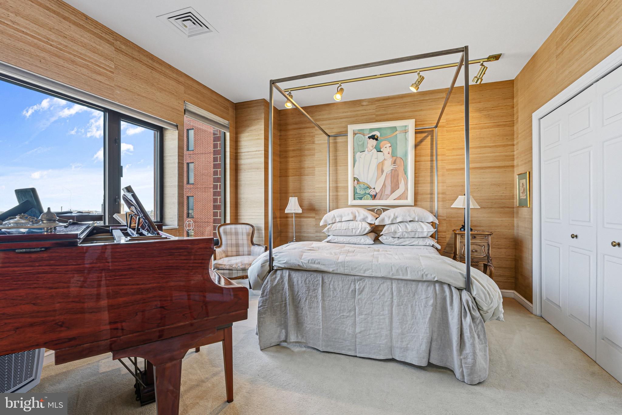 10 East Lee Street, Unit 2008 Baltimore, MD 21202 - Photo 15 of 23 a bedroom with a bed and large windows