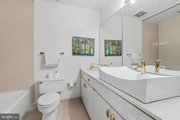 a view of bathroom with a toilet sink and mirror