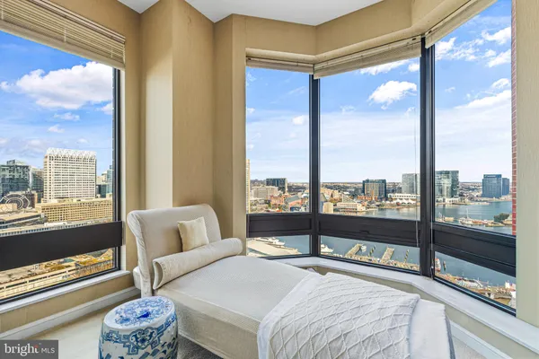a bedroom with furniture and a large window